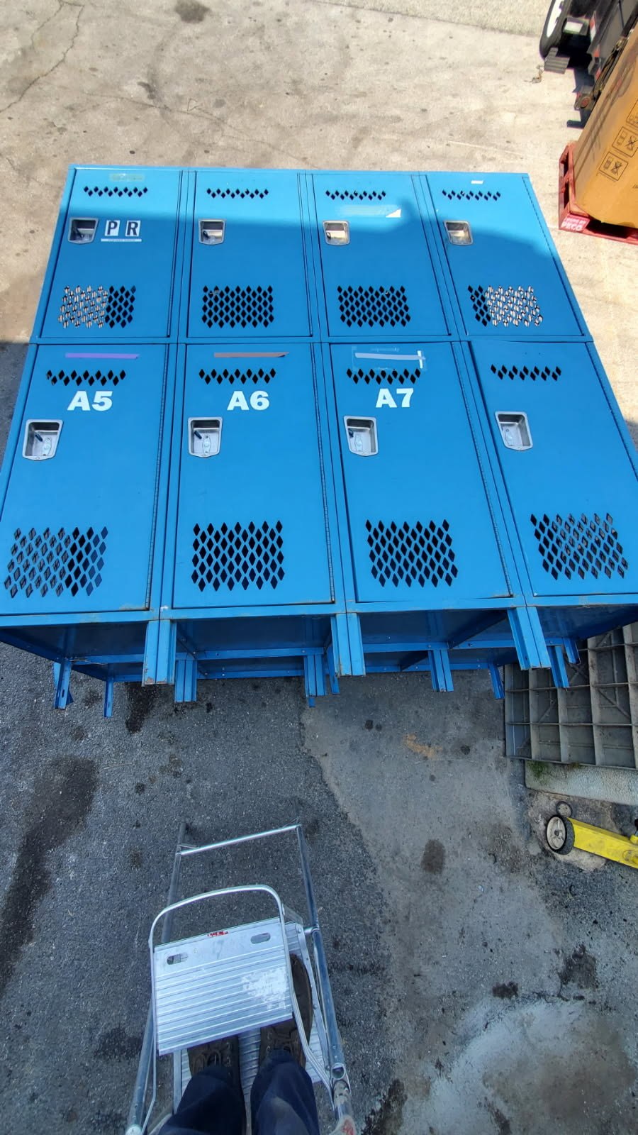 Blue steel two-tier gym lockers, two banks of four doors over four