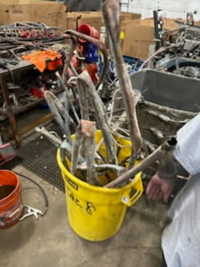 Sorted scrap metal in a bucket at the shop